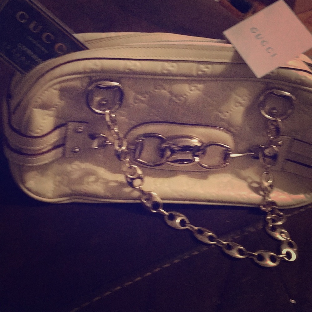 It’s a cream white Gucci Purse